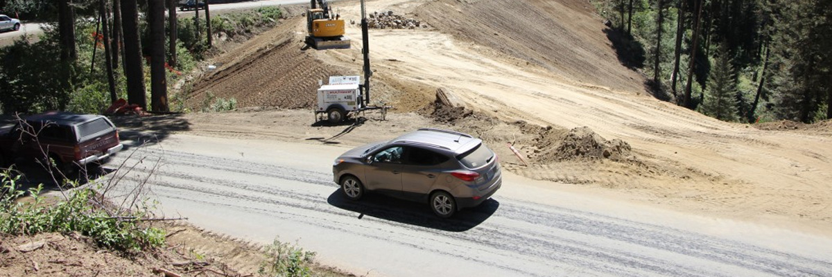 Cars drive through construction zone