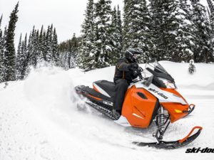 Man rides orange Ski-Doo Snowmobile