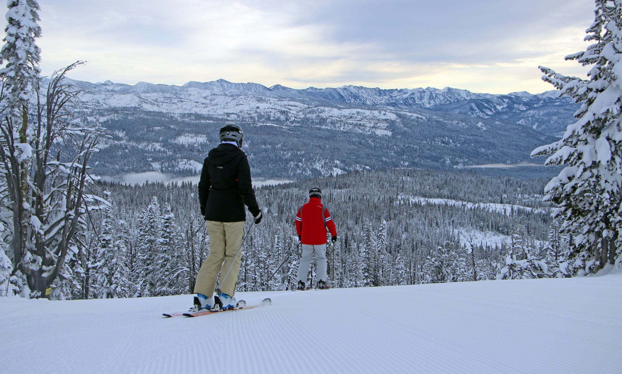 Two skiers at top of Kickback with view