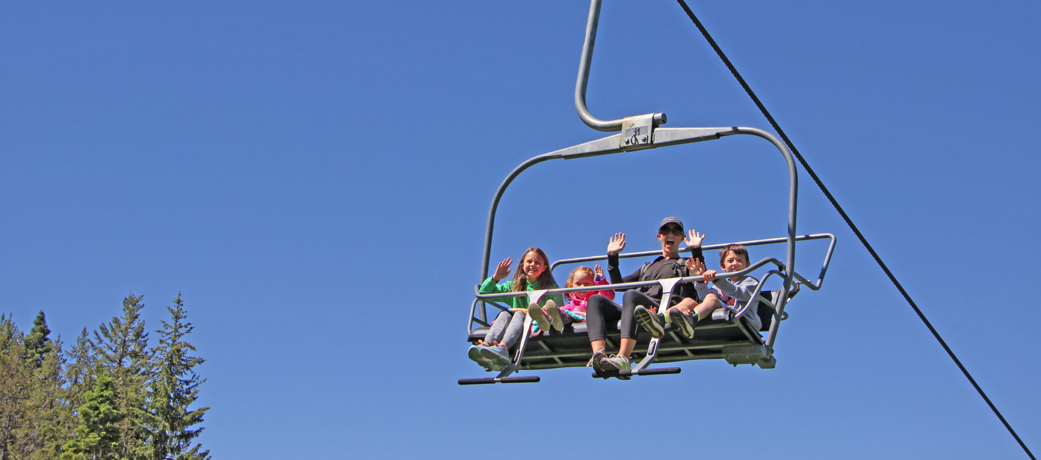 family waves from chairlift