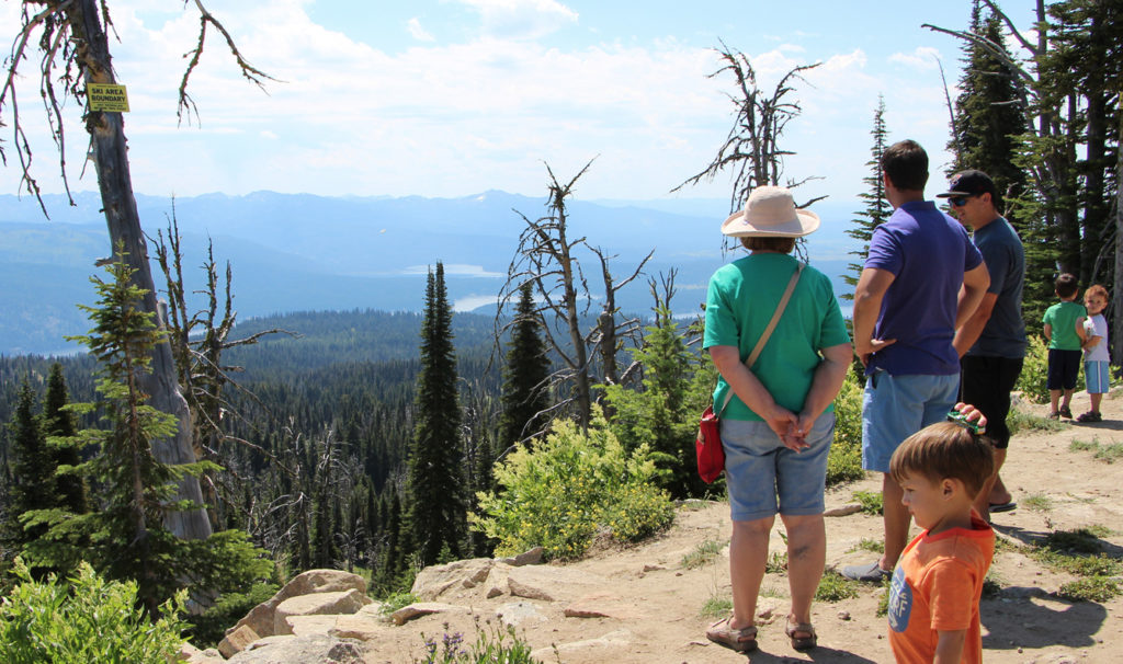 Family enjoys the view from the summit in summer