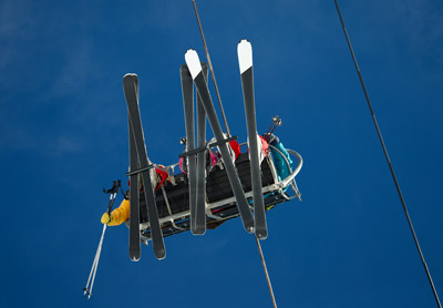 Best powder slopes at Brundage Mountain Resort showing skier riding alpine terrain down winter trails with scenic mountain views and chairlift accessing backcountry runs