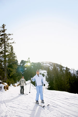 Skiers and people enjoying night skiing at Brundage ski area with chairlifts, lessons, and rentals available; season pass benefits include deals on tickets, plus info on nordic skiing at Little Ski Hill with plenty of adventures for kids and all experience levels